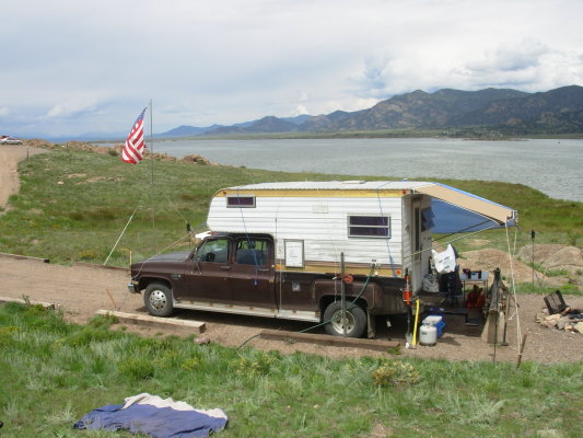 This is not our camper or our camp or our flag or our lake - but we did have a huge cabover camper on top of an old Jimmy.
